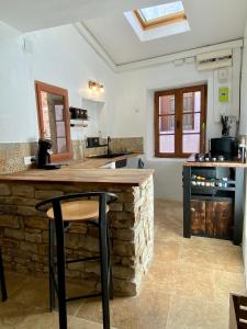a kitchen with a stone counter top in a room at Maison de village in Saint-Paulet-de-Caisson