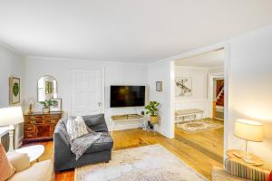a living room with a couch and a tv at Historic Catskills Farmhouse Ski, Hike and Relax! in Catskill