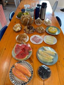 a wooden table with plates of food on it at Pousadinha do seu Manoel in Barreirinhas +31 photos
