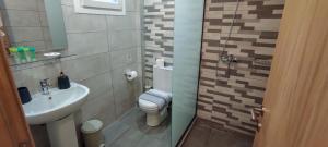 a small bathroom with a toilet and a sink at Anatoli Studios in Skala Rachoniou +34 photos