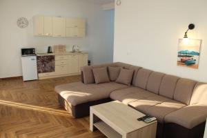 a living room with a couch and a table at Captain's View in Dobra Voda