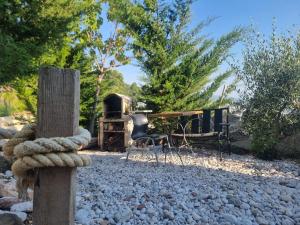 a bench and a table and chairs in a yard at Captain's View in Dobra Voda