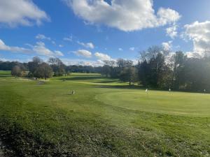 a view of a golf course with a green field at Charlotte Street 2 Bedroom Apartment in Ayr