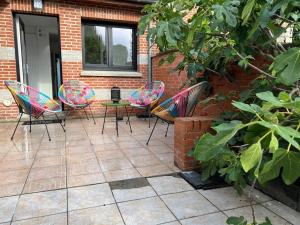 a group of chairs and a table on a patio at Maison idéale pour vos vacances in Faches-Thumesnil