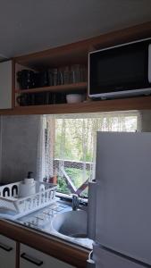 a kitchen counter with a sink and a window at Śniegocinka 4 in Brenna