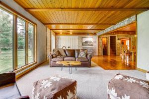 a living room with a couch and a table at Picturesque Lake Elmo Cottage with Fire Pits! in Lake Elmo