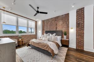 a bedroom with a brick wall and a bed at 204- City loft w parking & BBQ in Atlanta