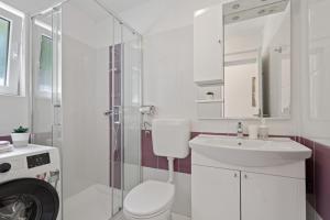 a bathroom with a toilet and a sink and a shower at Apartments Leonardo in Rabac +59 photos