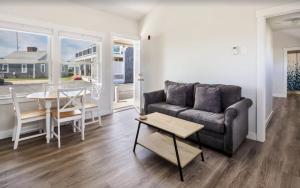 a living room with a couch and a table at Serene Condo for Cozy Cape Getaway in Truro