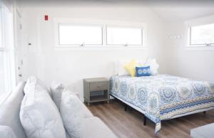 トゥルーロにあるFresh and Crisp Pet Friendly Studioのベッドとソファのある白い寝室 +6枚の写真