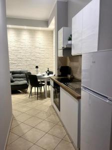 a kitchen with white appliances and a dining room at IL BALCONCINO di GR in Fondi