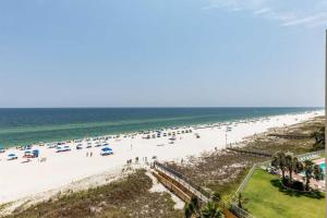 an overhead view of a beach with people and the ocean at The Enclave 606 in Orange Beach