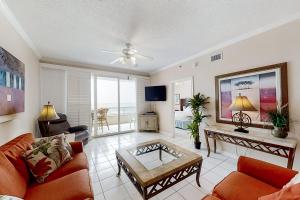 a living room with a couch and a table at The Enclave 606 in Orange Beach +37 photos