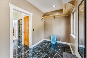 a hallway with a door and a tile floor at Custom 2BR & Loft Home, with Hot Tub & Stunning Views in Alma +40 photos