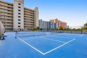 a tennis court in front of a building at The Enclave 606 in Orange Beach
