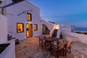 a patio with a table and chairs on a building at Blue Vine Villa - Private Pool - Panoramic Sea View in Kamari