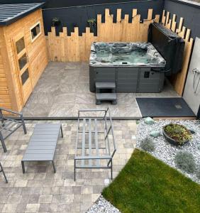 a backyard with a grill and a bench and a fence at Sauna et SPA en rez-de-jardin au pied de la montagne in Buhl