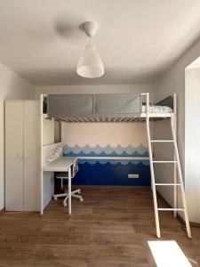 a bedroom with two bunk beds and a desk at Sauna et SPA en rez-de-jardin au pied de la montagne in Buhl +25 photos