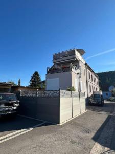 a building with a fence in front of it at Sauna et SPA en rez-de-jardin au pied de la montagne in Buhl