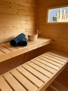 a wooden sauna with a tub with a bowl at Sauna et SPA en rez-de-jardin au pied de la montagne in Buhl