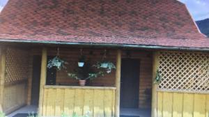 a house with a wooden gate and a red roof at Хатинка in Yaremche