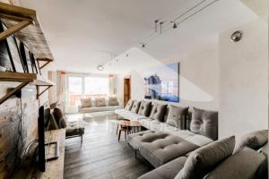 a large living room with couches and a table at Chalet De Meribel - Magnifique appartement 6 pièces pour 10 personnes dans le centre de Méribel proche des commerces et des pistes de ski MAE-1653 in Les Allues