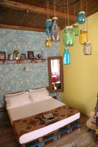 a bedroom with a bed and a mirror and lights at Famme sta cuiete appartamento Napoli centro in Naples