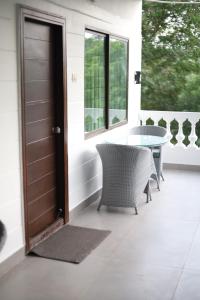 a front door of a house with a table and chairs at Button Eyes Resort - Pet friendly in Hyderabad