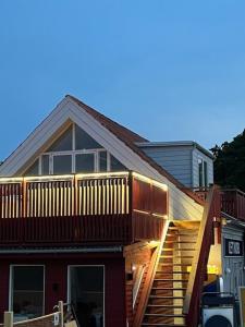 a house with a deck on the side of it at Kragenæs Havn in Torrig +5 photos