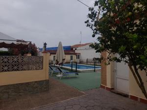 a view of a pool from a house with an umbrella at VERDEPLAYA in Matalascañas