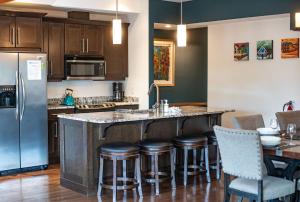 a kitchen with a large island with bar stools at Downunder Mountain Retreat in Revelstoke