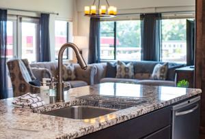 a kitchen with a sink and a living room at Downunder Mountain Retreat in Revelstoke