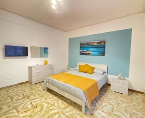 En eller flere senge i et værelse på Chiara Home