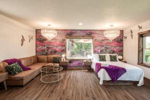 a living room with a bed and a couch at Boutique Hotel King, Queen & Kitchen Suites Easy Drive to Downtown in Prescott