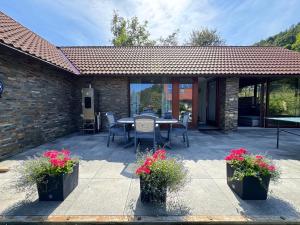 a patio with a table and chairs and flowers at U Pěti kohoutů in Liberec