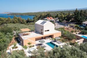 an aerial view of a house with a swimming pool at Nine Olives Hvar in Stari Grad