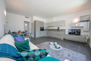 a living room with a couch and a tv at Sant' Agata Bellavista in Ossuccio