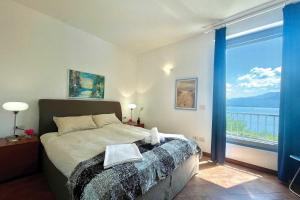 Un dormitorio con una cama y una ventana grande. en Gaeta 'Lake View', en San Siro