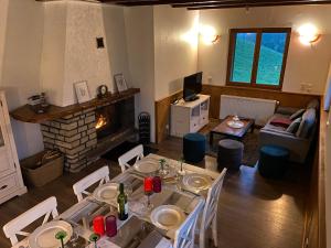 sala de estar con mesa de comedor y chimenea en Chalet L'Arbizon Campan, en Campan