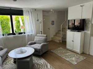 a living room with a couch chair and a tv at Casa Elah - Luxury Villa in Nerja
