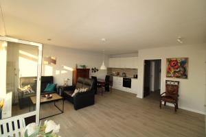 a living room with a couch and a table at Panorama Whg 25, 2 OG in Cuxhaven