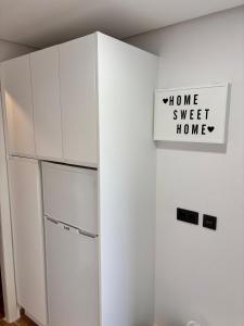 a white cabinet with a sign on a wall at Apartamento Seghers Estepona Playa y Sol in Estepona