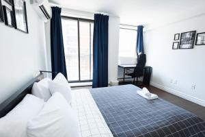 a hotel room with a bed and a window at Samesun Toronto in Toronto