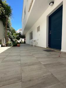 a large building with a large blue door at Villa Gardina in Raoued +5 photos