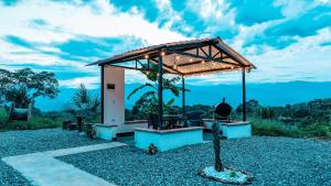 a gazebo with a table and chairs under it at El edén en sopetran con cuarto del amor in Sopetrán