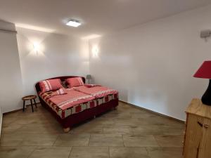 a bedroom with a bed with red pillows on it at Apartmán Sázava - Žďársko in Sázava