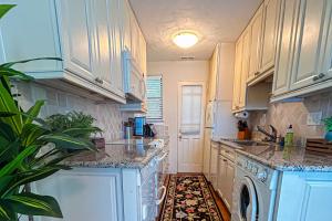 a kitchen with white cabinets and a dishwasher at Stone Cottage 1973 in Lake Junaluska +24 photos
