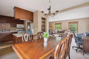 a kitchen and dining room with a wooden table and chairs at Stellar two bedroom home in Minneapolis
