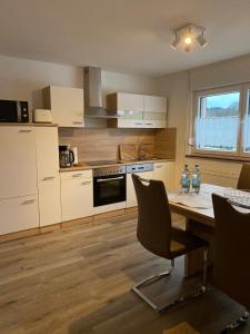 a kitchen with a table and chairs in a room at Ferienhaus Naturtraum Eifel in Gerolstein