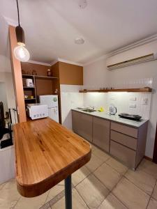 eine große Küche mit einem Holztisch darin in der Unterkunft Ayala Planta Alta in Santa Rosa + 21 Fotos